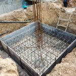 Foundation construction building site making reinforcement metal framework for pouring concrete. Metal mold for cement construction. Cement foundation for house building